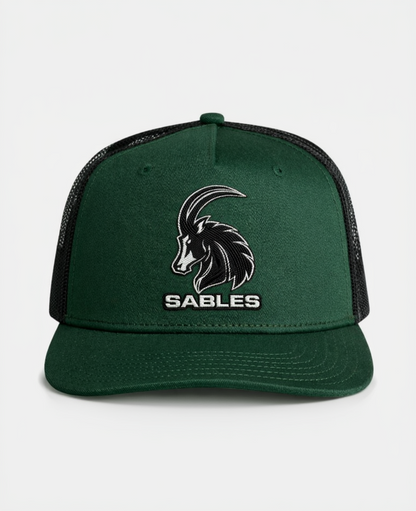 Green cap with black mesh and goat logo labeled 'Sables' on a white background