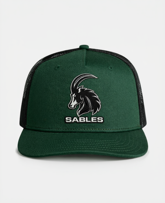 Green cap with black mesh and goat logo labeled 'Sables' on a white background